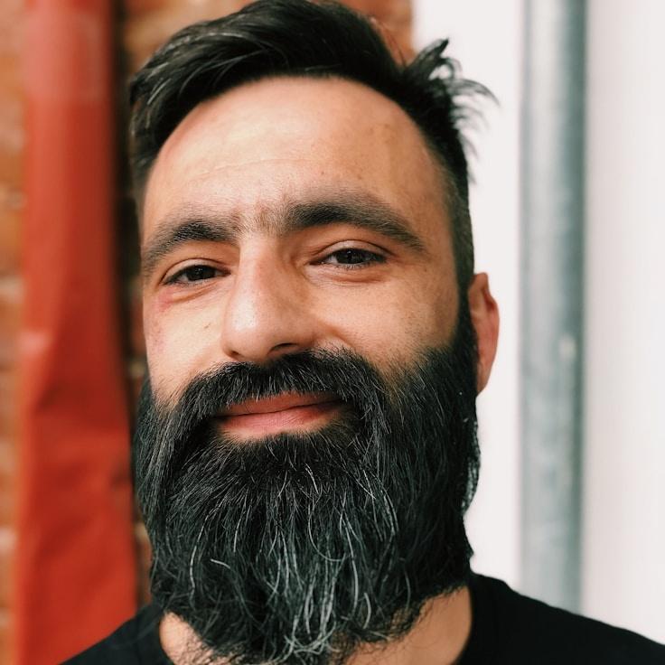 Avery Chen, Lead Design Curator at Harbor Prism Lane, reviewing corporate floral arrangements